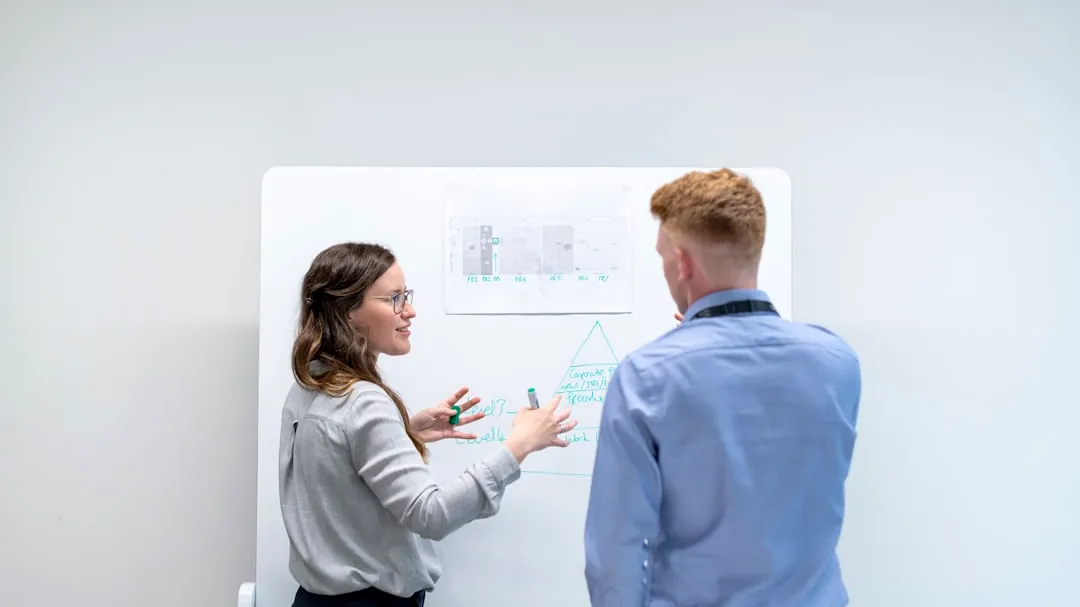 man in blue long sleeve shirt holding woman in gray sweater
