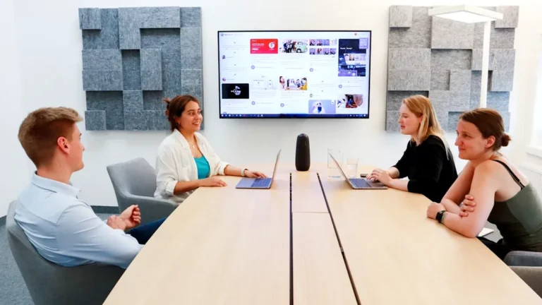 a group of people sitting around a conference table
