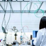 A female scientist conducting research in a contemporary laboratory full of equipment.