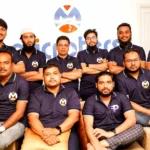 A group of men sitting next to each other