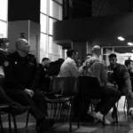A group of people sitting around a christmas tree