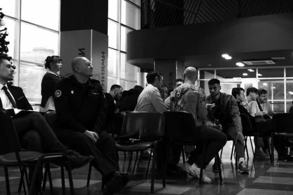 A group of people sitting around a christmas tree