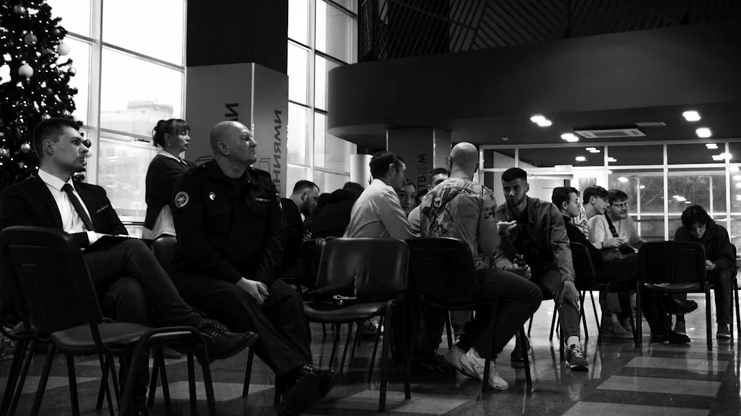 A group of people sitting around a christmas tree