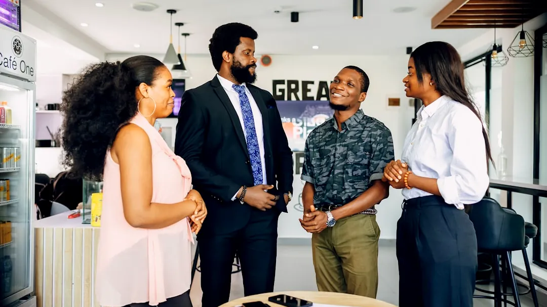A group of people standing around a table