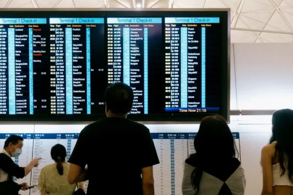 a group of people standing in front of a large screen
