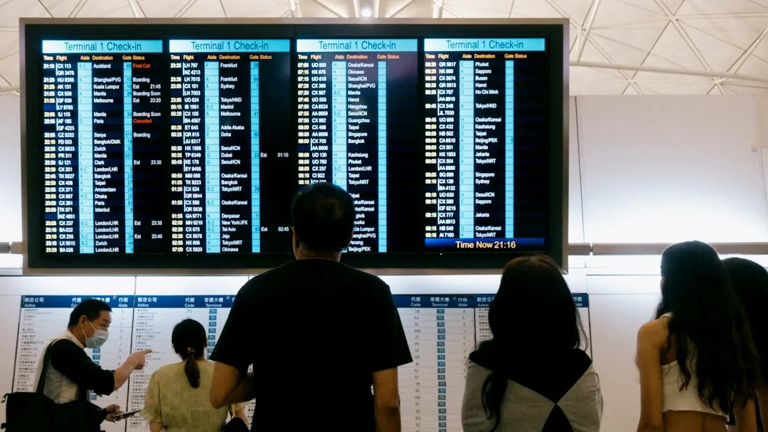 a group of people standing in front of a large screen