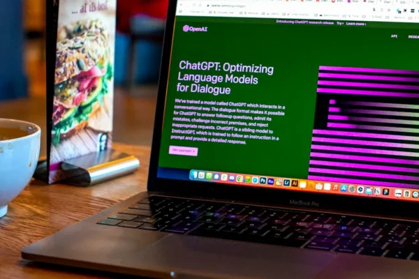 a laptop computer sitting on top of a wooden table