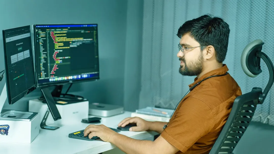 a man sitting at a desk using a computer