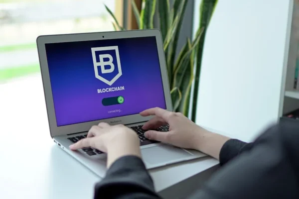 a person sitting at a table with a laptop