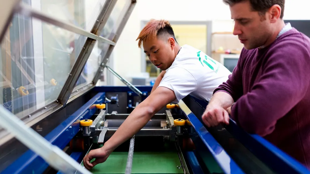boy in white and purple long sleeve shirt playing with black and yellow plastic toy