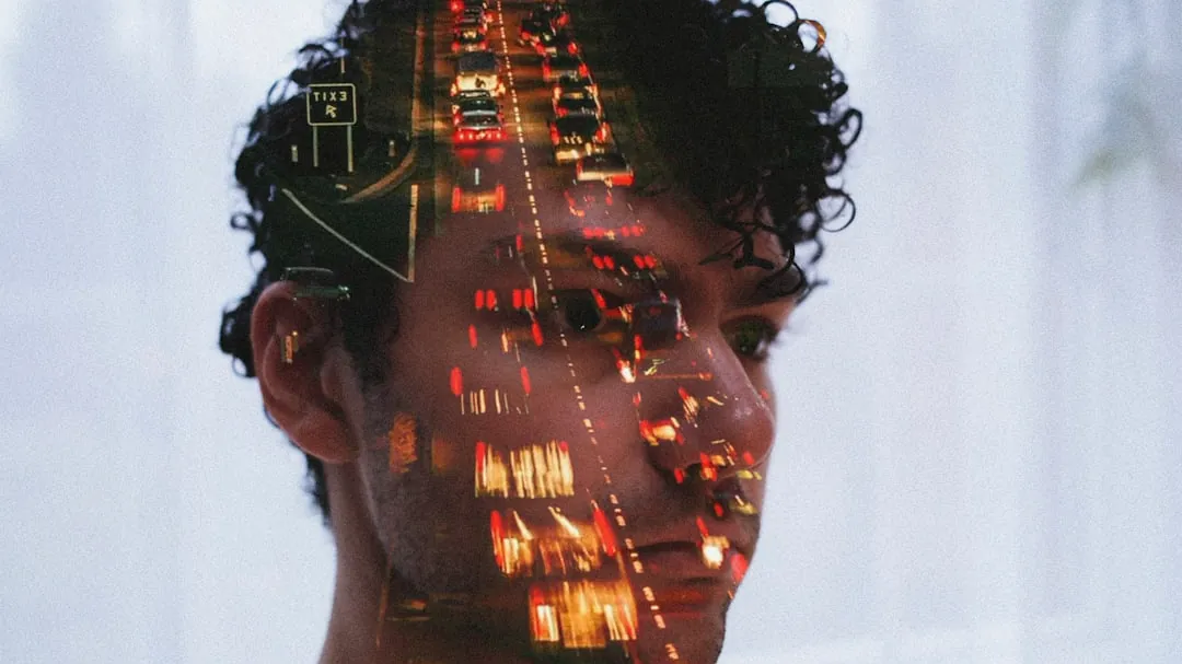 Double exposure of man's face and traffic lights