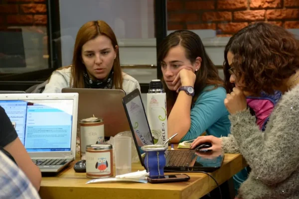 group of women sitting and using laptops