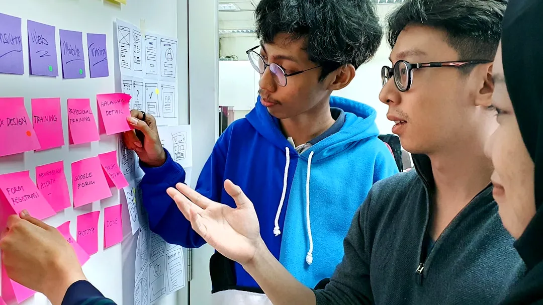 man in black framed eyeglasses holding purple and white box