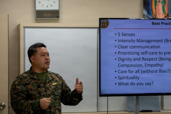 Man in military uniform presenting to a group.