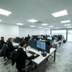 Office workers are busy working on computers.