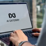 Person typing on laptop with ai gateway logo.