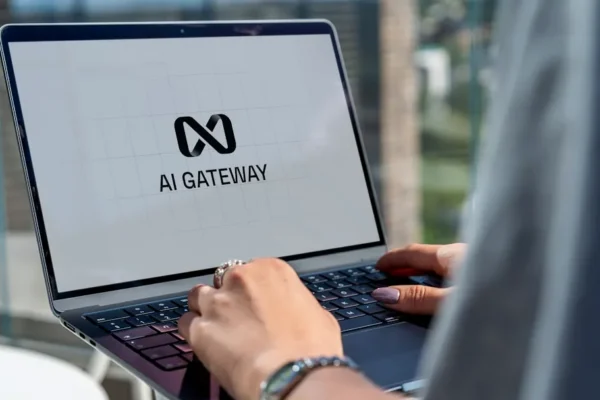 Person typing on laptop with ai gateway logo.