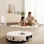 Robot vacuum cleans floor while family relaxes
