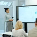 Woman presenting a graph to an audience