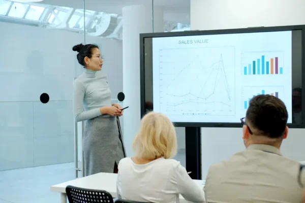 Woman presenting a graph to an audience
