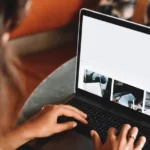 woman using macbook pro on table
