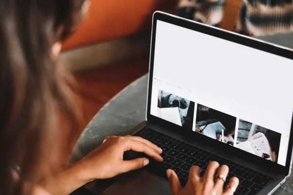 woman using macbook pro on table