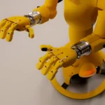 Yellow robot with articulated hands on a white background