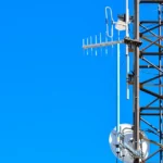 a cell phone tower with a cell phone on top of it